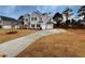 Gray two-story house with a long driveway and a spacious yard at 1441 Stephens View Dr, Loganville, GA 30052