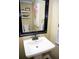 Small bathroom with pedestal sink and floating shelves at 4770 Quail Hunt Ct, Powder Springs, GA 30127