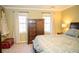 Bright bedroom featuring a king-size bed and dresser at 4770 Quail Hunt Ct, Powder Springs, GA 30127