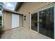 Back patio features a sliding glass door, white door, concrete, and exterior light fixture at 382 Northdale Ct, Lawrenceville, GA 30046
