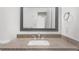Bathroom vanity features a granite countertop, a modern sink and faucet, and a stylish beveled mirror at 382 Northdale Ct, Lawrenceville, GA 30046