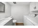 Bathroom with a modern vanity, commode, tile floors, and in-unit washer/dryer at 382 Northdale Ct, Lawrenceville, GA 30046