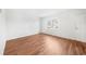 Bedroom with hardwood floors, white walls, natural light, and a side door at 382 Northdale Ct, Lawrenceville, GA 30046
