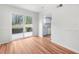 Hardwood floors, white trim, and sliding glass doors illuminate this versatile empty room at 382 Northdale Ct, Lawrenceville, GA 30046