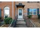 Brick townhouse entrance featuring a black awning over the door and wrought iron railings at 382 Northdale Ct, Lawrenceville, GA 30046