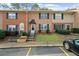 Charming brick townhome with well-maintained landscaping, dark shutters, and visible parking at 382 Northdale Ct, Lawrenceville, GA 30046