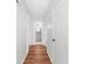 Hallway with hardwood floors, white walls, and access to bathroom at 382 Northdale Ct, Lawrenceville, GA 30046