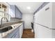 Kitchen with granite countertops, stainless steel sink, and wooden floors at 382 Northdale Ct, Lawrenceville, GA 30046