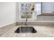 Kitchen sink with granite countertops, chrome faucet, and backyard view at 382 Northdale Ct, Lawrenceville, GA 30046