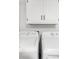 Laundry room features a white washer and dryer and matching white cabinets at 382 Northdale Ct, Lawrenceville, GA 30046