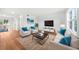 Bright, furnished living room with modern decor, hardwood floors, and a view of the outdoor patio at 382 Northdale Ct, Lawrenceville, GA 30046