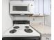 Kitchen featuring granite countertops, a white tile backsplash, and a Whirlpool microwave at 382 Northdale Ct, Lawrenceville, GA 30046