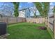 Fenced backyard with grassy lawn, seating area, and fire pit at 453 Mary Sw St, Atlanta, GA 30310