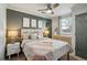Cozy bedroom with a queen-size bed, ceiling fan, and modern decor at 453 Mary Sw St, Atlanta, GA 30310