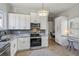 Modern kitchen with white cabinets, granite countertops, and stainless steel appliances at 453 Mary Sw St, Atlanta, GA 30310