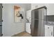 Compact laundry area with a full-size refrigerator and stacked washer/dryer at 453 Mary Sw St, Atlanta, GA 30310