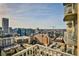 A stunning urban view from a balcony shows the city's skyline, featuring modern buildings on a bright, sunny day at 860 Peachtree Ne St # 2506, Atlanta, GA 30308