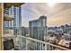 Enjoy breathtaking city views from this condo's private balcony overlooking modern skyscrapers and sunny skies at 860 Peachtree Ne St # 2506, Atlanta, GA 30308