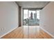 Bright bedroom with hardwood floors and a stunning city view from the large windows at 860 Peachtree Ne St # 2506, Atlanta, GA 30308