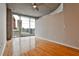 Bright bedroom with hardwood floors, ceiling fan, and a stunning city view from the large windows at 860 Peachtree Ne St # 2506, Atlanta, GA 30308
