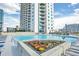 Relax by the community pool surrounded by colorful flowers and lounge chairs, perfect for enjoying sunny days at 860 Peachtree Ne St # 2506, Atlanta, GA 30308