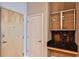 Hallway showing storage cabinets with granite countertop with a light wood entry door at 860 Peachtree Ne St # 2506, Atlanta, GA 30308