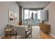 Contemporary living room featuring hardwood floors and large windows showcasing city skyline views at 860 Peachtree Ne St # 2506, Atlanta, GA 30308