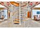 Unique spiral staircase adds architectural detail to a modern interior, complemented by stone walls and elegant lighting at 860 Peachtree Ne St # 2506, Atlanta, GA 30308