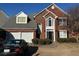 Brick two-story house with a two-car garage and landscaped yard at 2075 Carlysle Park Ln, Lawrenceville, GA 30044