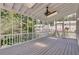 Spacious screened porch with wood flooring and ceiling fan at 2075 Carlysle Park Ln, Lawrenceville, GA 30044