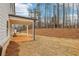View of the home's back exterior featuring a covered patio and a spacious backyard at 261 Martin Spring Rd, Lawrenceville, GA 30045