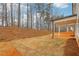 A backyard view featuring a covered patio and an expanse of newly laid sod at 261 Martin Spring Rd, Lawrenceville, GA 30045