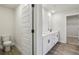 Bathroom featuring toilet, double vanity with white cabinets, and wood look floors at 261 Martin Spring Rd, Lawrenceville, GA 30045