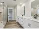 Bathroom featuring glass shower enclosure, double vanity, and wood look floors at 261 Martin Spring Rd, Lawrenceville, GA 30045
