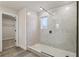 Bathroom featuring glass shower enclosure, tile surround, and vinyl floors at 261 Martin Spring Rd, Lawrenceville, GA 30045