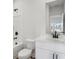 Bright bathroom featuring a tub, vanity with white countertops and modern fixtures at 261 Martin Spring Rd, Lawrenceville, GA 30045