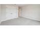 A view of a carpeted bedroom with double doors leading to a closet and an open doorway at 261 Martin Spring Rd, Lawrenceville, GA 30045