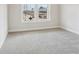 Bright, carpeted bedroom with a double window overlooking the outdoors at 261 Martin Spring Rd, Lawrenceville, GA 30045