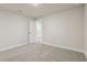 Neutrally decorated bedroom with carpet floors and access to adjacent rooms at 261 Martin Spring Rd, Lawrenceville, GA 30045
