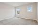 Bright bedroom with two windows, neutral walls and carpet at 261 Martin Spring Rd, Lawrenceville, GA 30045