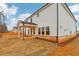 Exterior view showcasing a house with a covered patio and an unfinished backyard at 261 Martin Spring Rd, Lawrenceville, GA 30045