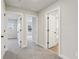 Hallway showing carpet floors and white paneled doors to adjacent rooms at 261 Martin Spring Rd, Lawrenceville, GA 30045