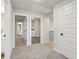 Bright hallway with carpet flooring and white trim leading to various rooms, including the laundry at 261 Martin Spring Rd, Lawrenceville, GA 30045