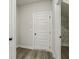 Hallway with grey wood flooring and a door to a walk-in closet at 261 Martin Spring Rd, Lawrenceville, GA 30045