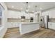 Bright kitchen features an island with pendant lighting, and stainless steel appliances at 261 Martin Spring Rd, Lawrenceville, GA 30045