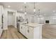 Open-concept kitchen features an island with granite countertops and stainless steel appliances at 261 Martin Spring Rd, Lawrenceville, GA 30045