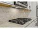 The kitchen is equipped with modern appliances, granite countertops, and a stylish backsplash at 261 Martin Spring Rd, Lawrenceville, GA 30045