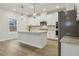 Well-lit kitchen with an island, stainless steel appliances, and white cabinets at 261 Martin Spring Rd, Lawrenceville, GA 30045