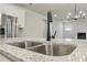 Close-up of a kitchen sink with modern faucet and view into the kitchen at 261 Martin Spring Rd, Lawrenceville, GA 30045