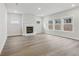Spacious living room featuring a modern fireplace, hardwood floors, and abundant natural light at 261 Martin Spring Rd, Lawrenceville, GA 30045